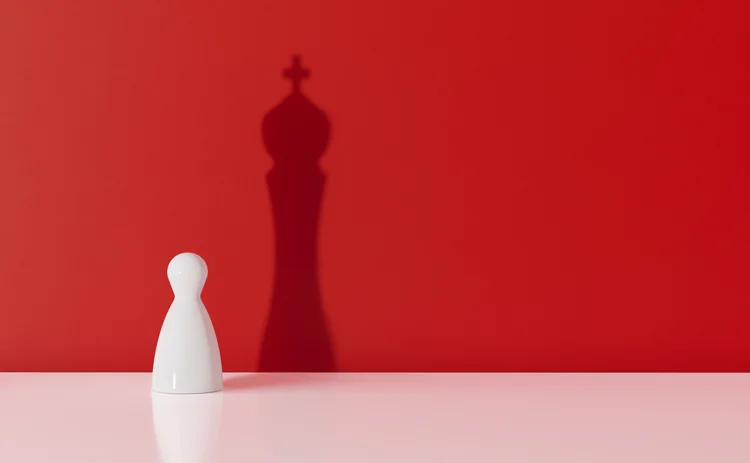 white pawn with king shadow on red background