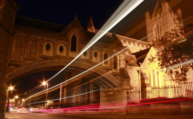 traffic-zooming-past-cathedral-at-night