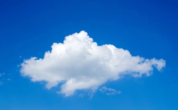 A single cloud floating in a clear blue sky