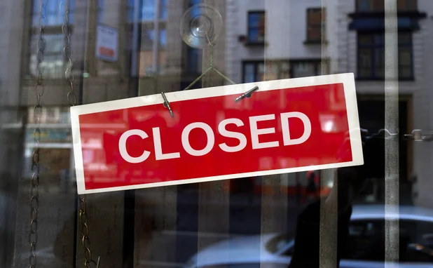 Red closed sign on glass