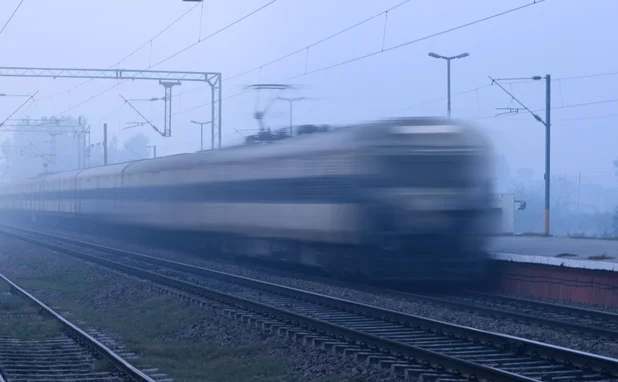 Train running in high speed blurred motion and crossing the station.