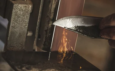 Close-up of a Man Sharpening a Knife.