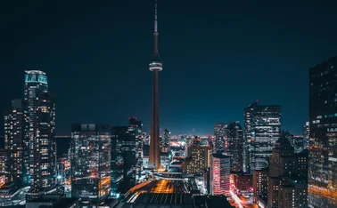 Futuristic and modern skyline views of downtown Toronto with the train tracks leading your eye to office buildings and condominiums.