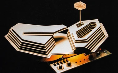 Architect’s hotel model on top of a reel-to-reel tape recorder, from the album cover of Tranquility Base Hotel + Casino by Arctic Monkeys