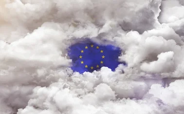 EU flag appearing through a gap in the clouds