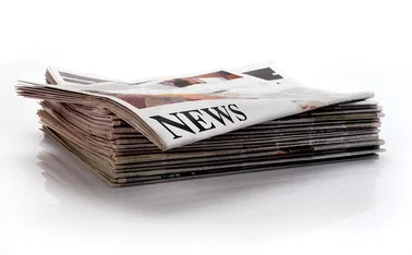 Stack of newspapers with news headlines_for CMS