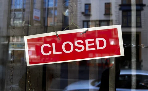 Red closed sign on glass