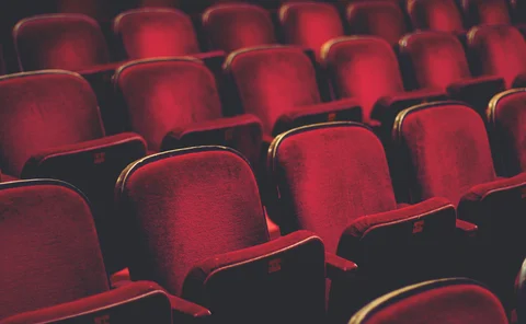 Empty comfortable red seats with numbers in cinema - stock photo