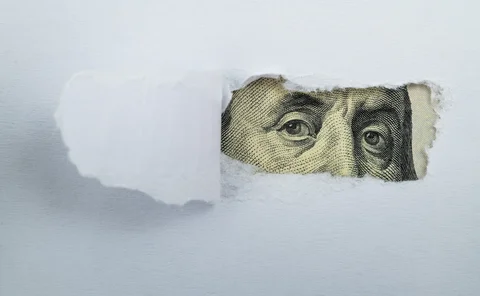 Torn white paper revealing US Currency - stock photo