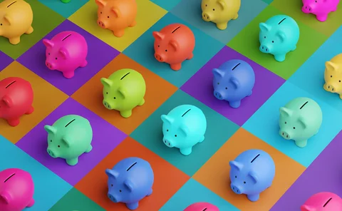 Array of piggy banks in saturated colours on high colour contrast background. Illustration of the concept of bank savings, financial investment and multiple sources of income - stock photo