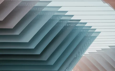 Abstract architectural pattern of overlapping geometric panels with soft blue tones and shadows