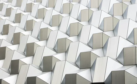 Abstract pattern of interconnected white geometric structures representing data networks, technology and digital infrastructure