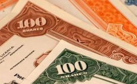 Pile of multi-coloured 100-share stock certificates