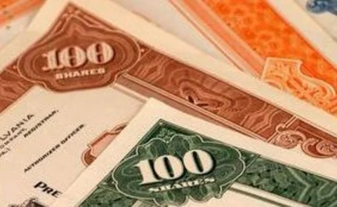 Pile of multi-coloured 100-share stock certificates
