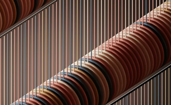 Abstract geometric artwork with stacked circular discs and vertical lines in earthy tones of red, brown, beige and black, creating a modern architectural pattern.