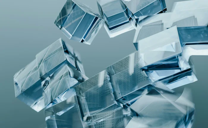 Abstract composition of translucent blue and silver geometric blocks floating against a grey background
