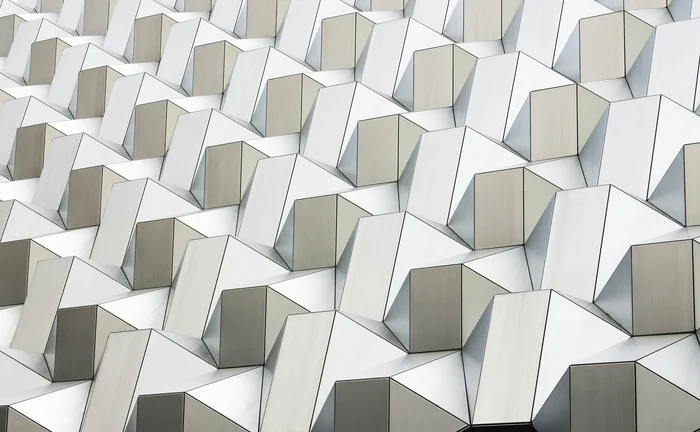 Abstract pattern of interconnected white geometric structures representing data networks, technology and digital infrastructure