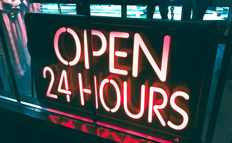 red neon sign reads "open 24 hours"