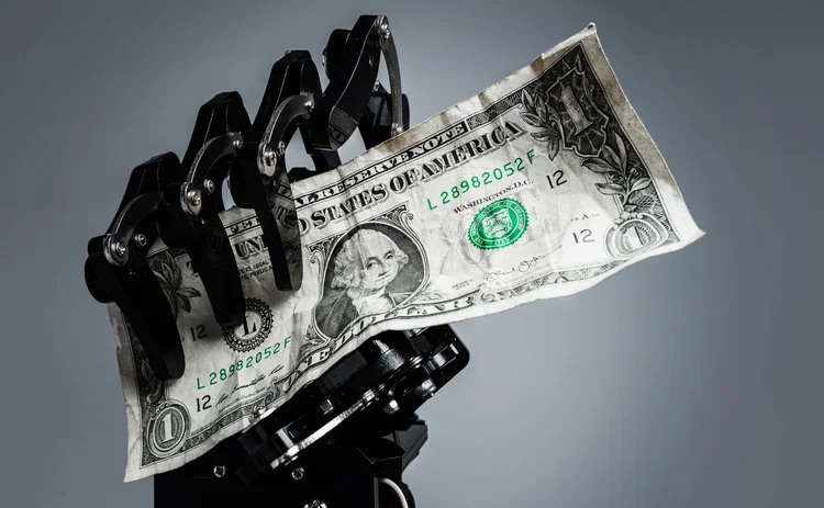 Real robotic hand with one dollar bill. Concepts of investment in Artificial intelligence technology or job replacement by AI.
