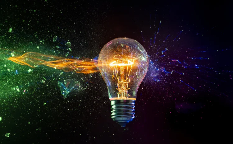 destruction of traditional tungsten bulb on black background