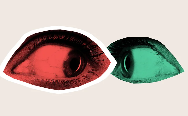 Two eyes in red and green staring intensely at each other, suggesting a silent yet absurd confrontation in communication. - stock photo