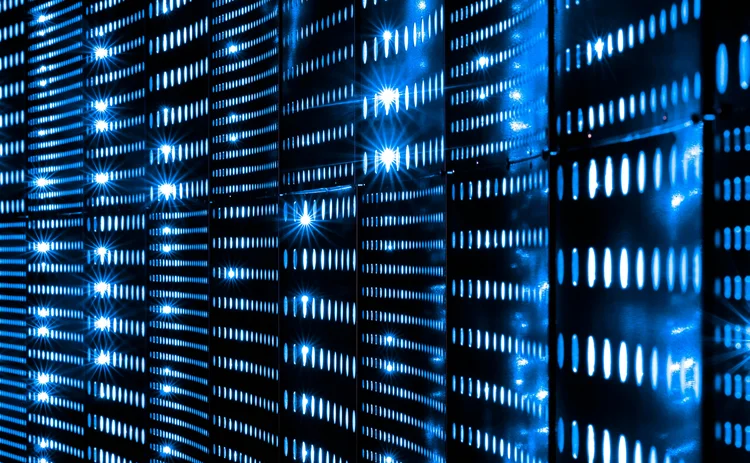 Close-up view of glowing blue LED lights on data server racks in a dark data center, representing cloud computing, cybersecurity, and digital infrastructure
