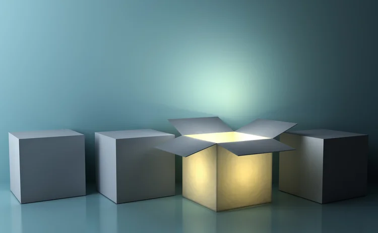 One luminous opened box glowing among closed white square boxes on dark green background with reflections and shadows - stock photo