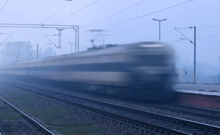Train running in high speed blurred motion and crossing the station.