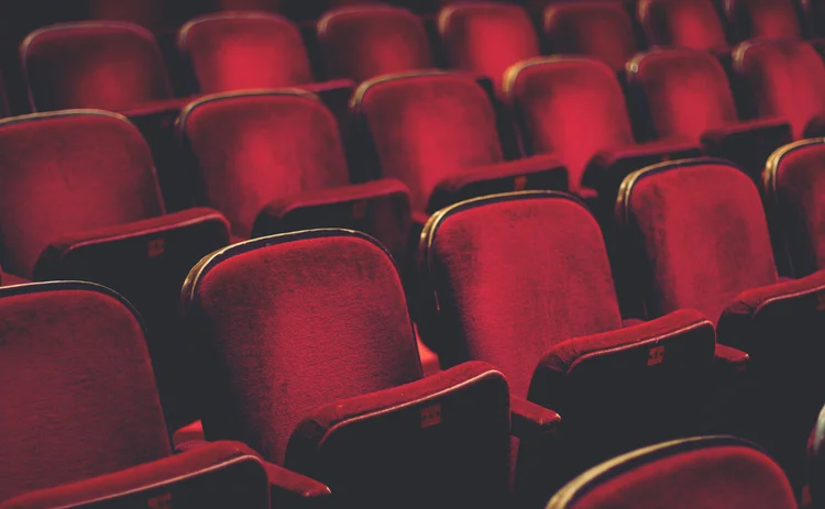 Empty comfortable red seats with numbers in cinema - stock photo