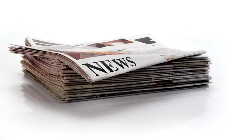 Stack of newspapers with news headlines_for CMS