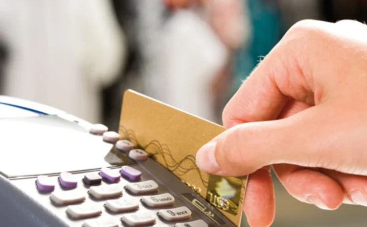 A woman making a credit card payment