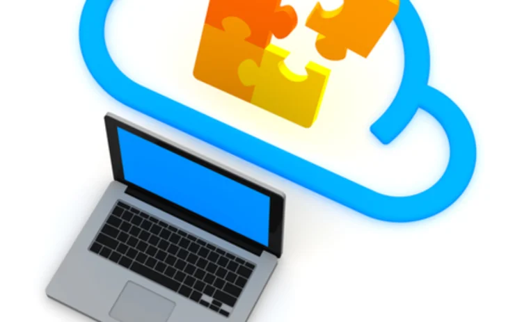 A graphic of a jigsaw in the cloud emerging from a laptop A graphic of a jigsaw in the cloud emerging from a laptop
