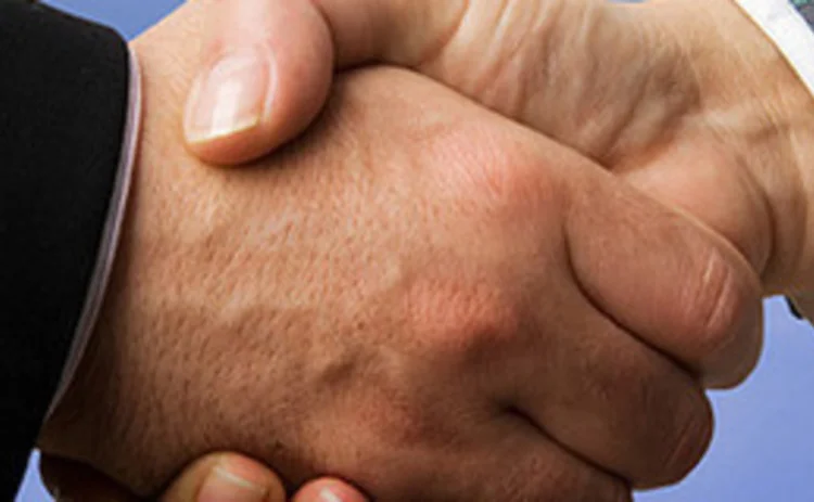 Two men hand shaking with blue skies in the background