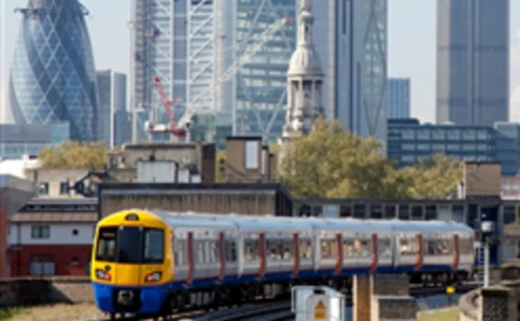 Train leaving London with City skyline behind