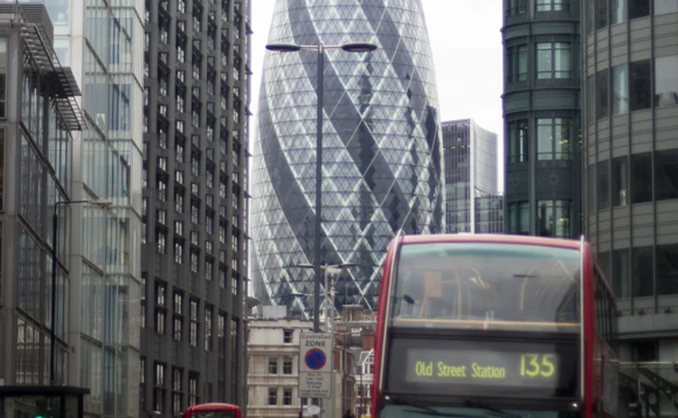 The financial centre of City of London with Swiss Re Building and London bus