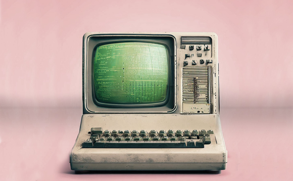 An old, dirty computer on pink background