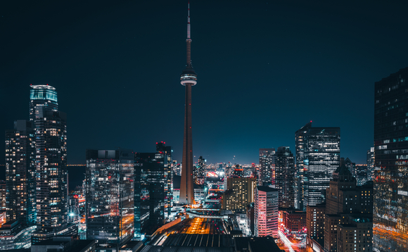 Futuristic and modern skyline views of downtown Toronto with the train tracks leading your eye to office buildings and condominiums.
