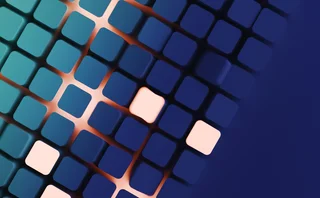 3D-rendered abstract image of a grid of rounded squares in gradient shades of blue and teal, with a few squares glowing in soft pink, creating a pattern of light and contrast against a dark blue background.