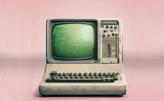 An old, dirty computer on pink background