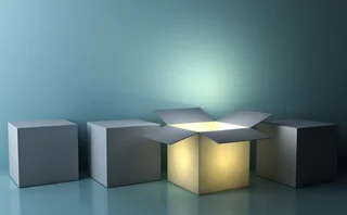 One luminous opened box glowing among closed white square boxes on dark green background with reflections and shadows - stock photo