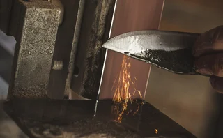 Close-up of a Man Sharpening a Knife.
