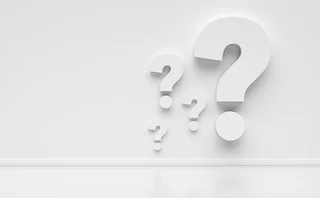 Question mark symbols on a white wall with copy space. - stock photo