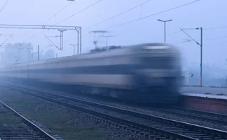 Train running in high speed blurred motion and crossing the station.