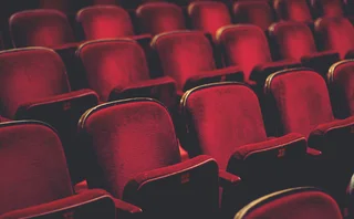 Empty comfortable red seats with numbers in cinema - stock photo