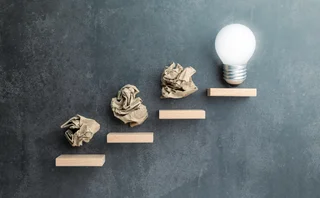 Steps with trash leading to a lightbulb