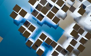Abstract geometric composition of interconnected white structures with dark rectangular blocks and blue highlights