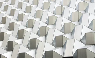 Abstract pattern of interconnected white geometric structures representing data networks, technology and digital infrastructure