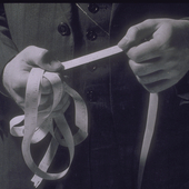 Man holding ticker tape showing stock prices
