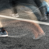 People running in marathon on city streets. Motion blur.