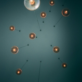 Modern cluster of glass globe pendant lights with exposed filament bulbs providing warm ambient lighting in a high-ceiling room